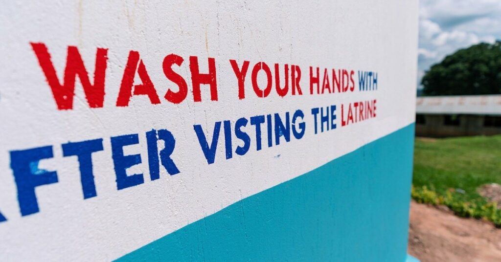 A sign on a latrine in Africa that reads "Wash Your Hands After Visiting the Latrine"