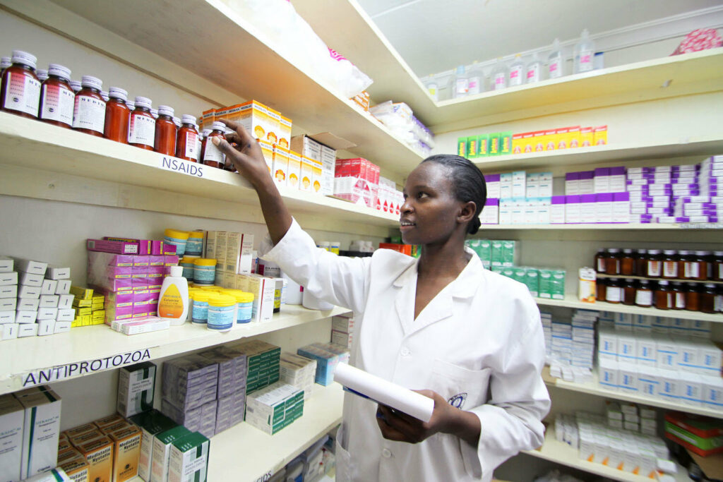 beacon of hope health worker looking through medicine shelf