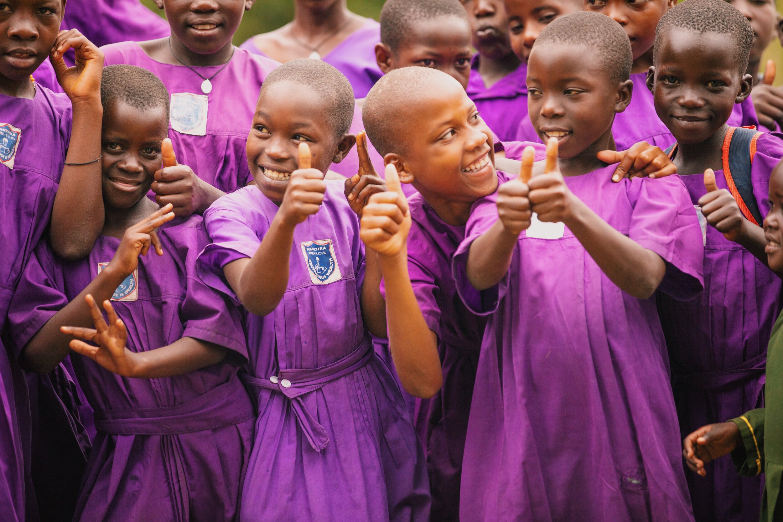 group of ugandan students giving thumbs up