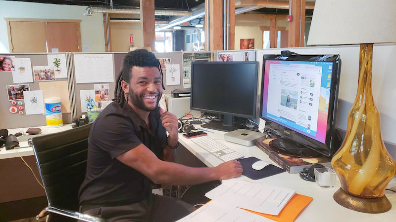 man smiling at work desk