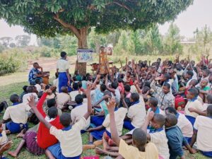 water, sanitation, and hygiene training taking place outside with group of people