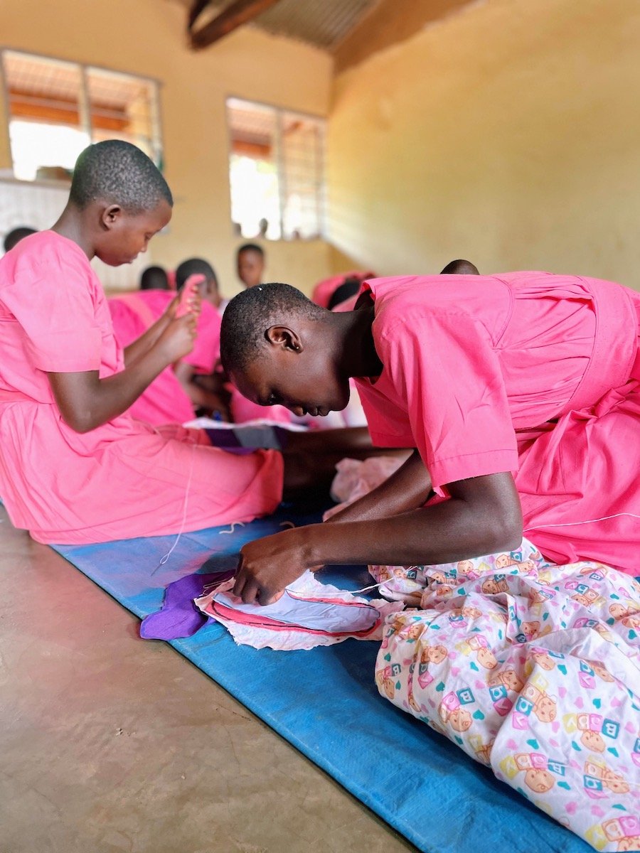 girl sewing reusable menstrual pad