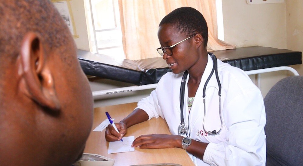 olps health worker writing at a table