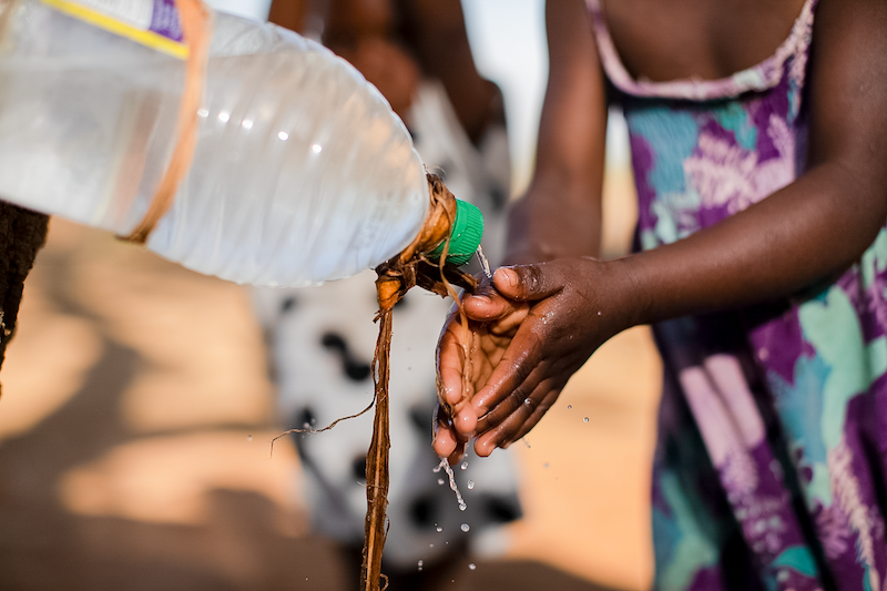 girl washing her hands at a handwashing station installed by copred in africa