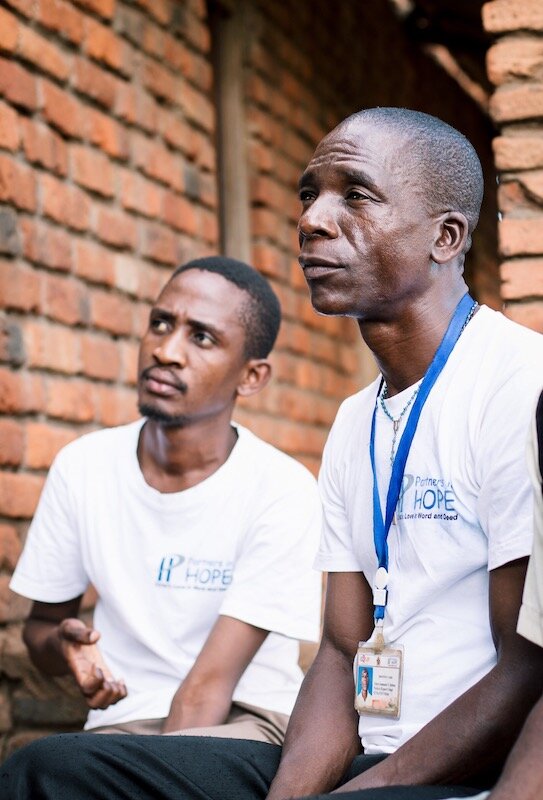 two expert hiv clients sit, listening