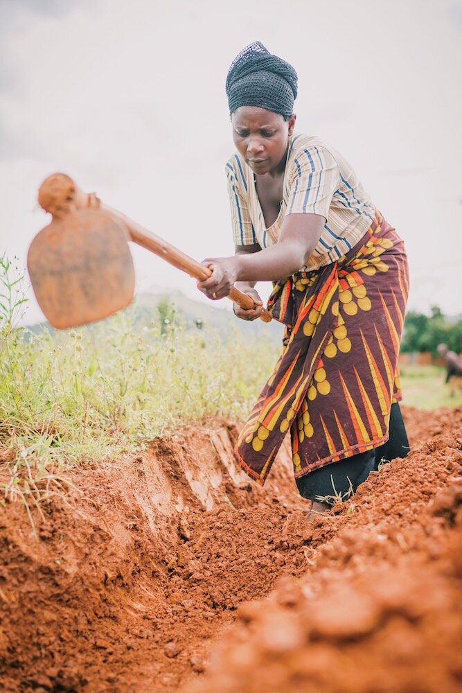 woman digging to make way for the construction of a water pipeline