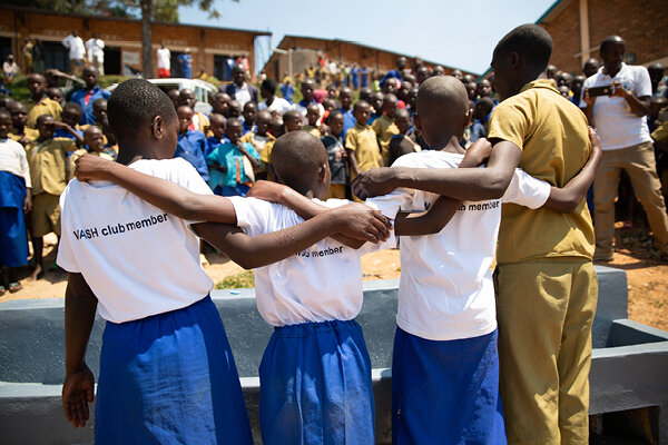 wash club members join together to celebrate a new water well, which will help alleviate poverty in their community