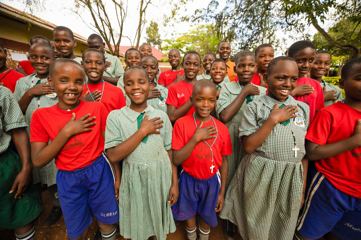 school children stand together for a photo as they say thank you to the christian charity that helped bring their school clean water