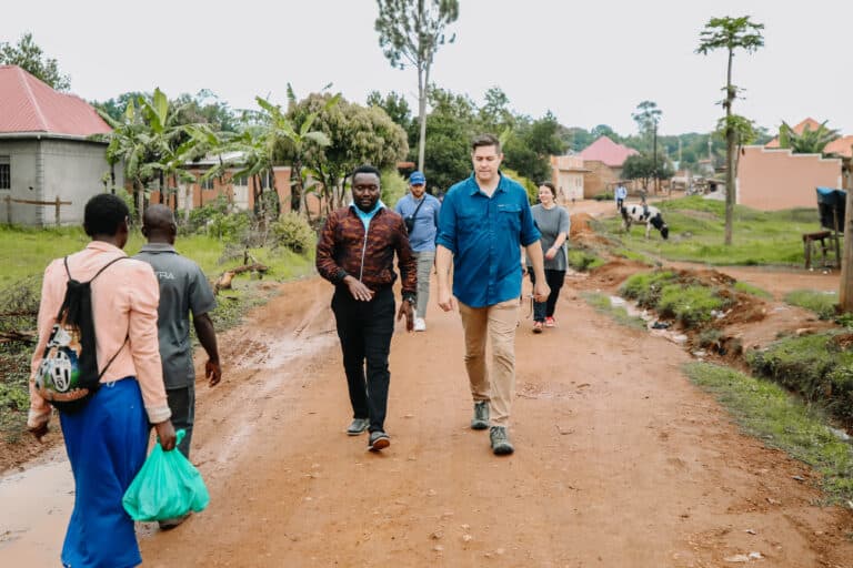 Blood:Water team members walking through an African village