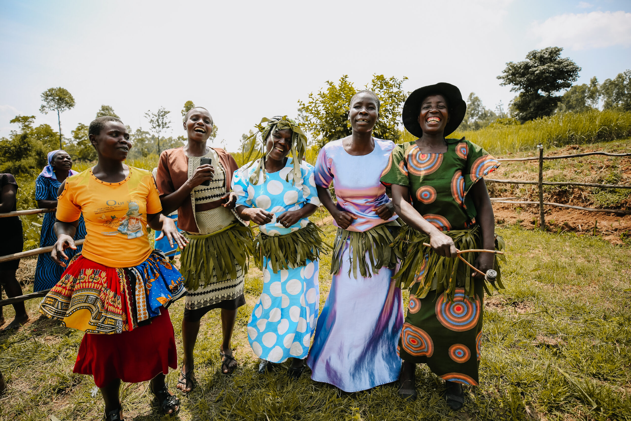 5 African women dancing and laughing